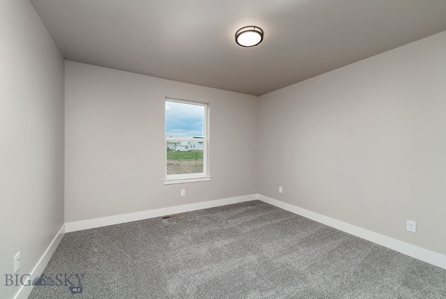 2204 Oriole Dr, Belgrade, MT 59714 - unfurnished room with dark carpet and baseboards
