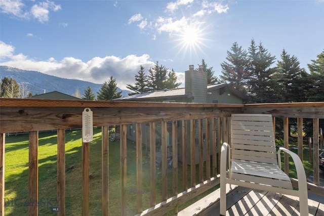 139 Spruce Cone Dr Unit 14, Big Sky, MT 59716 - wooden deck with a mountain view and a lawn