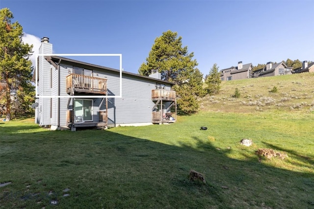 139 Spruce Cone Dr Unit 14, Big Sky, MT 59716 - rear view of property featuring a chimney and a lawn