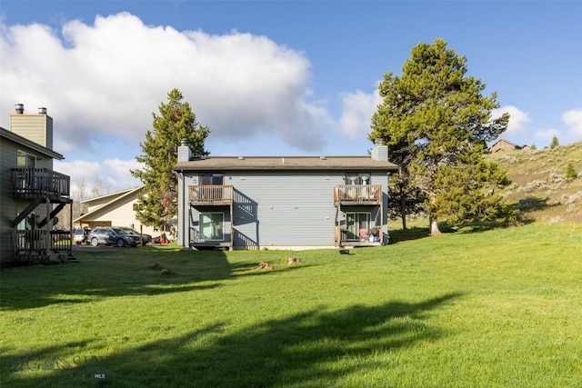 139 Spruce Cone Dr Unit 14, Big Sky, MT 59716 - rear view of property featuring a lawn and a chimney