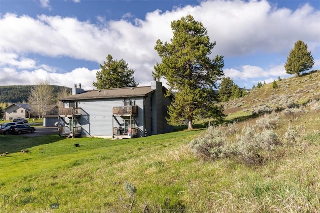 139 Spruce Cone Dr Unit 14, Big Sky, MT 59716 - view of green lawn featuring stairway and a deck