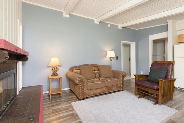 139 Spruce Cone Dr Unit 14, Big Sky, MT 59716 - living room with beamed ceiling, a large fireplace, and wood finished floors