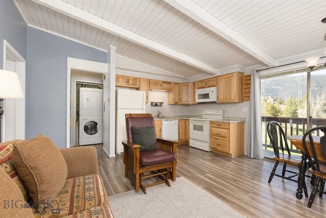 139 Spruce Cone Dr Unit 14, Big Sky, MT 59716 - kitchen featuring white appliances, stacked washer and clothes dryer, wood finished floors, light brown cabinets, and wood ceiling