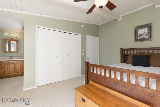 139 Spruce Cone Dr Unit 14, Big Sky, MT 59716 - bedroom featuring light colored carpet, a closet, a ceiling fan, and connected bathroom