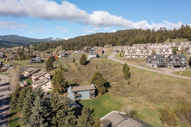 139 Spruce Cone Dr Unit 14, Big Sky, MT 59716 - aerial perspective of suburban area with a heavily wooded area and a mountain backdrop