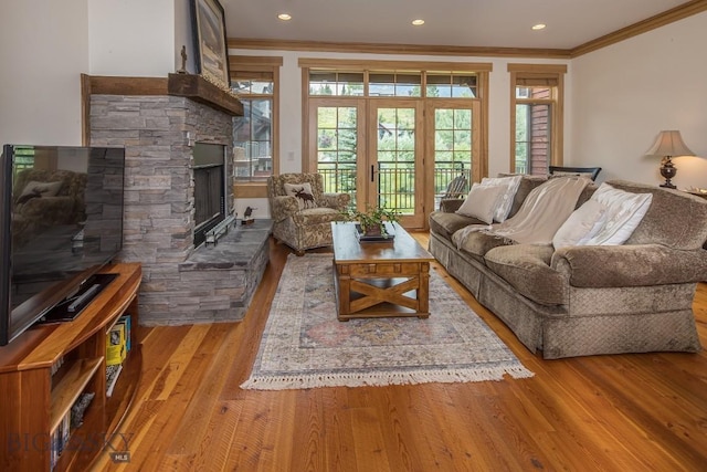 2500 Little Coyote Rd Unit 34, Big Sky, MT 59716 - living area featuring crown molding, wood finished floors, healthy amount of natural light, a fireplace, and recessed lighting