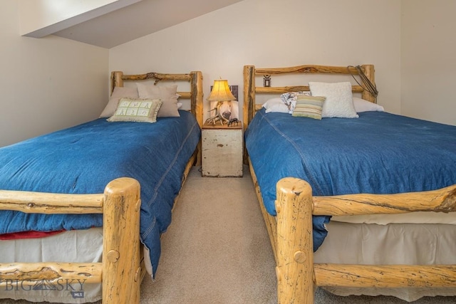 2500 Little Coyote Rd Unit 34, Big Sky, MT 59716 - carpeted bedroom featuring lofted ceiling