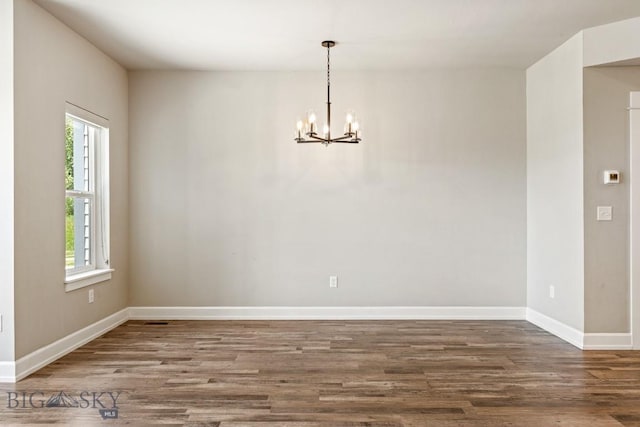 6707 Blackwood Rd Unit C, Bozeman, MT 59715 - unfurnished dining area with a chandelier, healthy amount of natural light, and wood finished floors