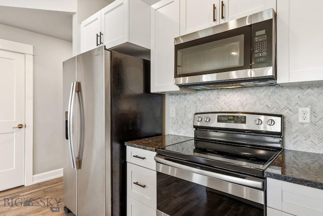 6707 Blackwood Rd Unit C, Bozeman, MT 59715 - kitchen with appliances with stainless steel finishes, white cabinetry, and light wood finished floors