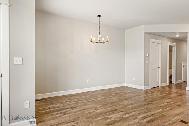 6707 Blackwood Rd Unit C, Bozeman, MT 59715 - spare room featuring wood finished floors, a chandelier, and recessed lighting