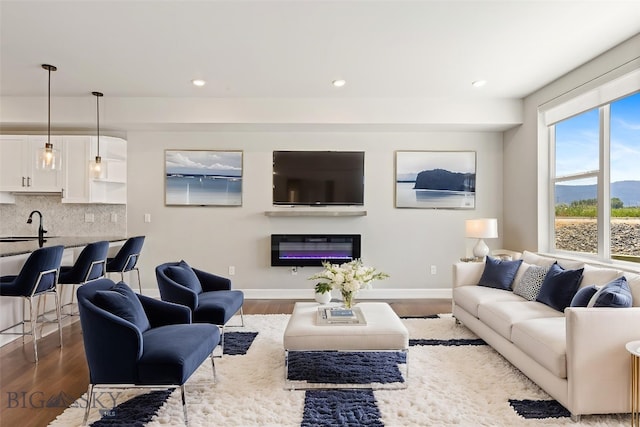 6707 Blackwood Rd Unit C, Bozeman, MT 59715 - living area with dark wood-style floors, recessed lighting, and a glass covered fireplace