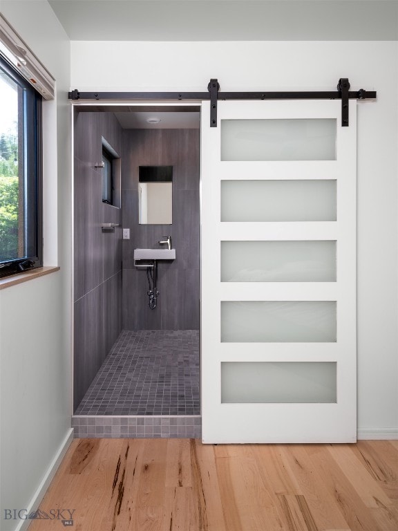 1206 N Cedarview Dr, Bozeman, MT 59715 - bathroom with tiled shower, wood finished floors, and built in shelves