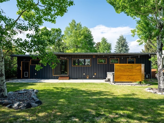 1206 N Cedarview Dr, Bozeman, MT 59715 - view of front of house featuring board and batten siding and a front lawn