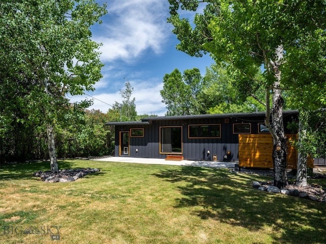 1206 N Cedarview Dr, Bozeman, MT 59715 - back of house with board and batten siding and a yard