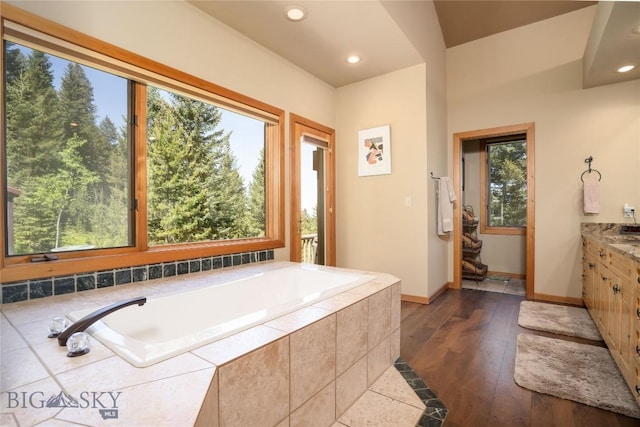 709 Limestone Rd, Bozeman, MT 59715 - bathroom with vanity, plenty of natural light, a bath, recessed lighting, and hardwood / wood-style flooring