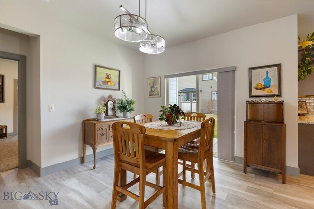 1308 Scooter Ln, Belgrade, MT 59714 - dining room with a chandelier and light wood-style floors