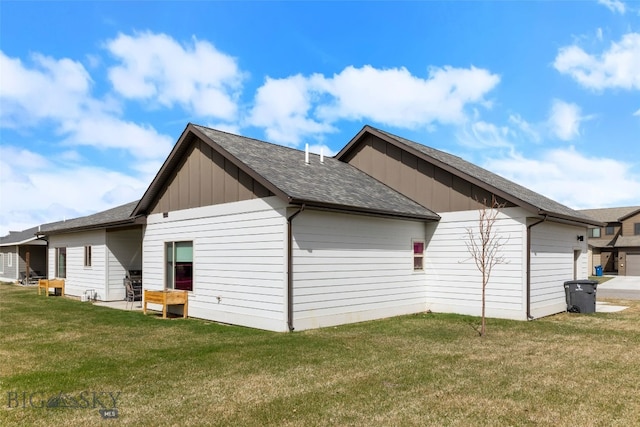 1308 Scooter Ln, Belgrade, MT 59714 - view of property exterior with board and batten siding, a yard, and a shingled roof