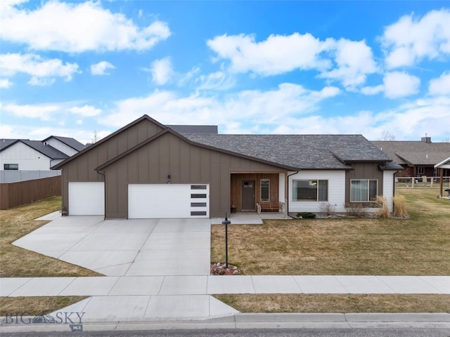 1308 Scooter Ln, Belgrade, MT 59714 - view of front facade featuring board and batten siding, a garage, concrete driveway, roof with shingles, and covered porch