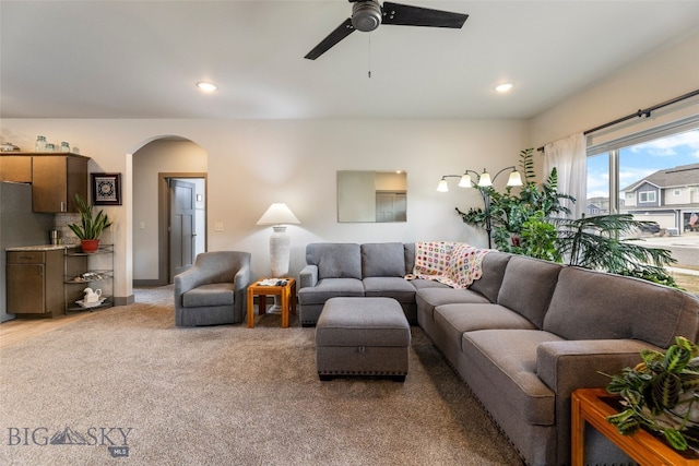 1308 Scooter Ln, Belgrade, MT 59714 - living room featuring arched walkways, light carpet, a ceiling fan, and recessed lighting