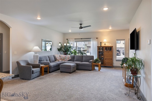 1308 Scooter Ln, Belgrade, MT 59714 - carpeted living room featuring arched walkways, a ceiling fan, and recessed lighting