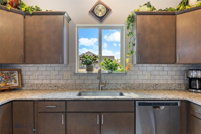 1308 Scooter Ln, Belgrade, MT 59714 - kitchen with stainless steel dishwasher, tasteful backsplash, dark brown cabinetry, and light stone countertops