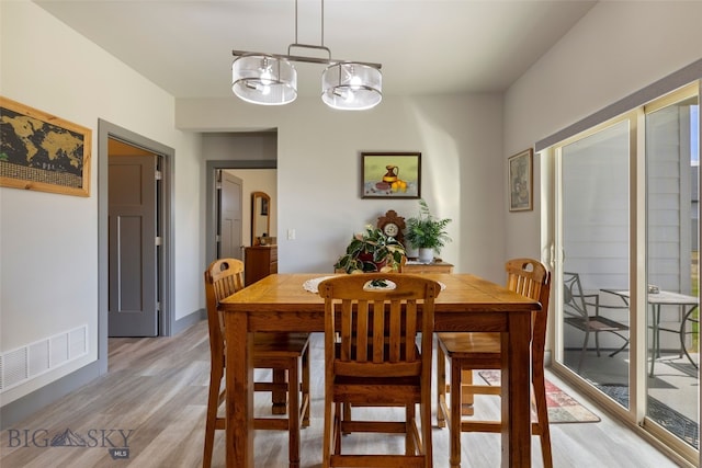 1308 Scooter Ln, Belgrade, MT 59714 - dining area featuring light wood-style floors and a chandelier