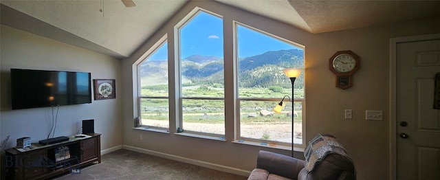 950 White Creek Ln, Polaris, MT 59746 - living room with carpet, healthy amount of natural light, a mountain view, lofted ceiling, and a ceiling fan