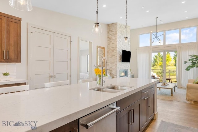 20 Caymus Ln Unit D, Bozeman, MT 59718 - kitchen featuring stainless steel dishwasher, open floor plan, pendant lighting, light stone countertops, and recessed lighting