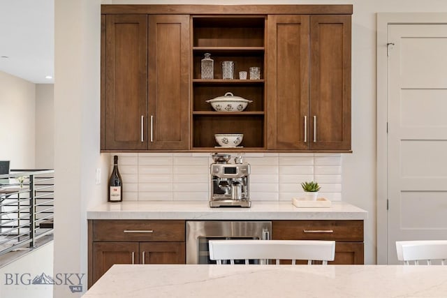 20 Caymus Ln Unit D, Bozeman, MT 59718 - kitchen featuring open shelves, tasteful backsplash, and light stone counters