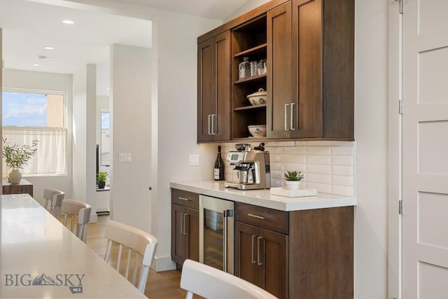 20 Caymus Ln Unit D, Bozeman, MT 59718 - kitchen with open shelves, beverage cooler, light countertops, backsplash, and light wood-style floors