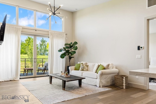 20 Caymus Ln Unit D, Bozeman, MT 59718 - living room with a chandelier, wood finished floors, and a high ceiling