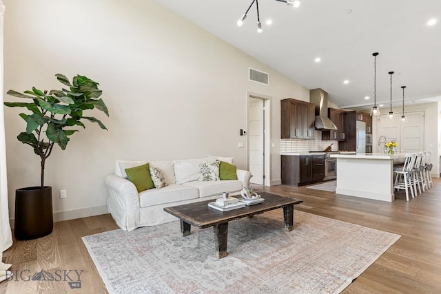 20 Caymus Ln Unit D, Bozeman, MT 59718 - living room featuring lofted ceiling, light wood finished floors, and recessed lighting