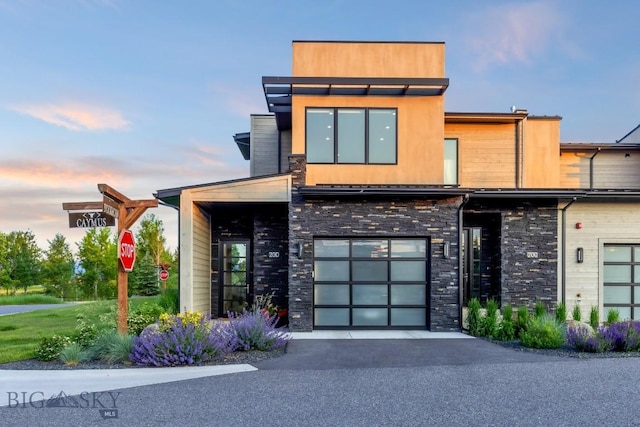 20 Caymus Ln Unit D, Bozeman, MT 59718 - contemporary house featuring stone siding, asphalt driveway, and a garage