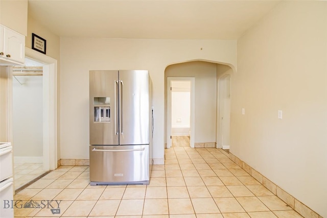 1823 Lafayette, Butte, MT 59701 - kitchen featuring high end refrigerator, arched walkways, white cabinets, and light tile patterned floors