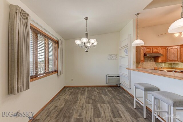 513 Burnham Pl, Helena, MT 59601 - kitchen featuring backsplash, a chandelier, an AC wall unit, dark wood-style floors, and decorative light fixtures