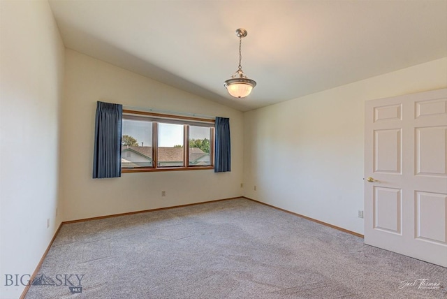 513 Burnham Pl, Helena, MT 59601 - spare room featuring light colored carpet and vaulted ceiling