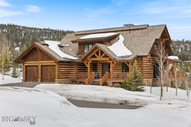 77 Tanager Frk Unit 29, Big Sky, MT 59716 - log-style house with covered porch, an attached garage, and stone siding