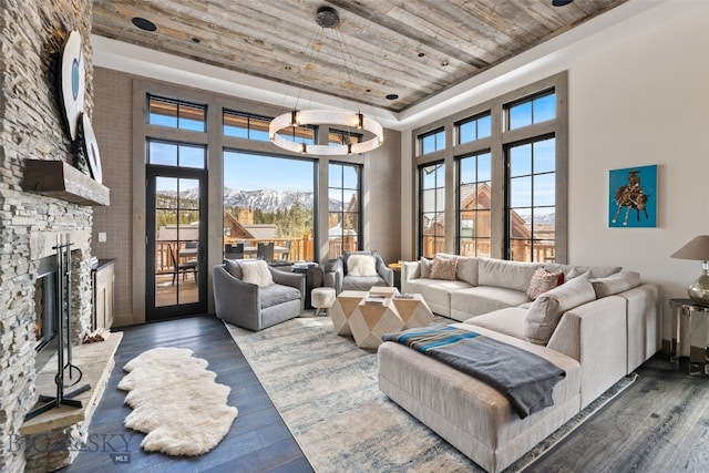 77 Tanager Frk Unit 29, Big Sky, MT 59716 - living area featuring wood ceiling, wood finished floors, a towering ceiling, a fireplace, and a mountain view
