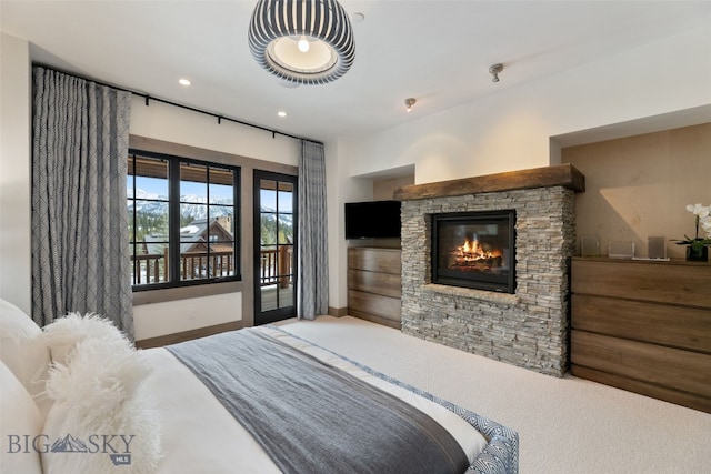 77 Tanager Frk Unit 29, Big Sky, MT 59716 - carpeted bedroom with access to exterior, a stone fireplace, and recessed lighting