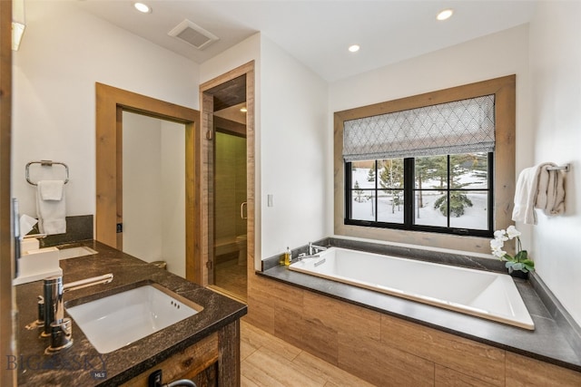 77 Tanager Frk Unit 29, Big Sky, MT 59716 - full bathroom with a garden tub, vanity, recessed lighting, and a shower stall
