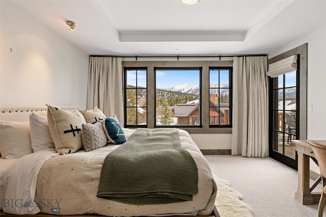 77 Tanager Frk Unit 29, Big Sky, MT 59716 - carpeted bedroom featuring access to outside, a raised ceiling, and a mountain view