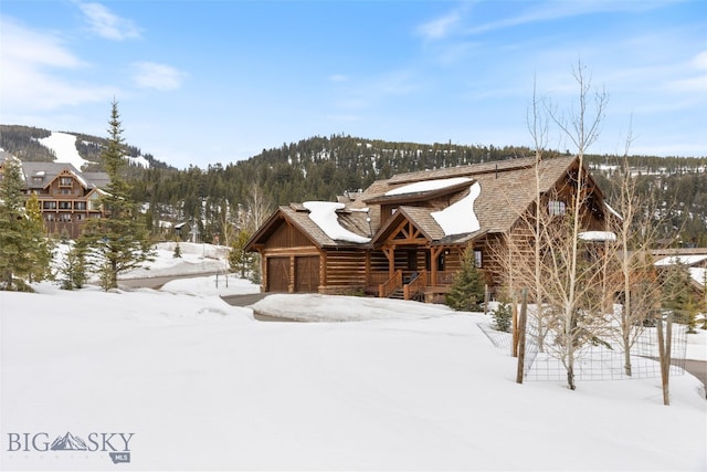 77 Tanager Frk Unit 29, Big Sky, MT 59716 - view of front of home featuring a garage and a mountain view