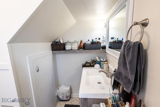 721 W Park Ave, Anaconda, MT 59711 - bathroom with vaulted ceiling and vanity