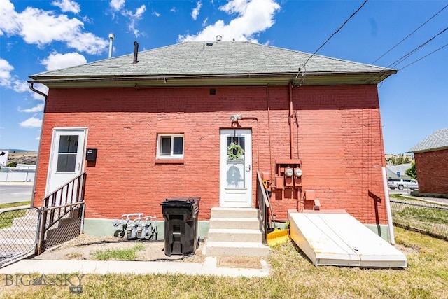721 W Park Ave, Anaconda, MT 59711 - back of house with entry steps, brick siding, and roof with shingles