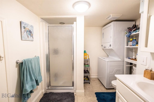 721 W Park Ave, Anaconda, MT 59711 - full bath featuring stacked washing machine and dryer, a shower stall, vanity, and tile patterned floors