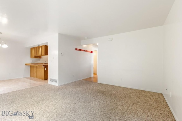 605 Prairie Ave, Bozeman, MT 59718 - unfurnished living room with light carpet and baseboards