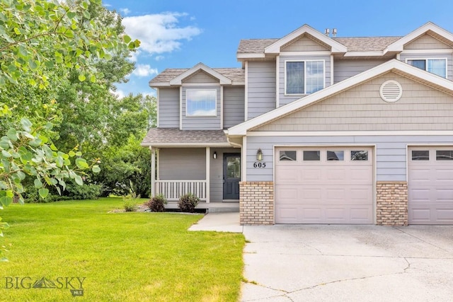 605 Prairie Ave, Bozeman, MT 59718 - townhome / multi-family property with driveway, a front yard, covered porch, a shingled roof, and brick siding