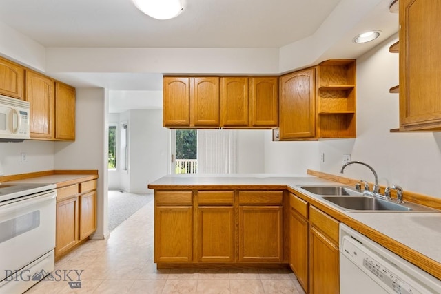 605 Prairie Ave, Bozeman, MT 59718 - kitchen with white appliances, light countertops, a peninsula, and brown cabinetry