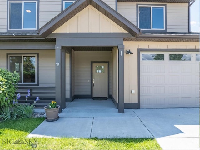 56 Koch Peak Ct, Bozeman, MT 59718 - doorway to property with board and batten siding, a garage, and a porch