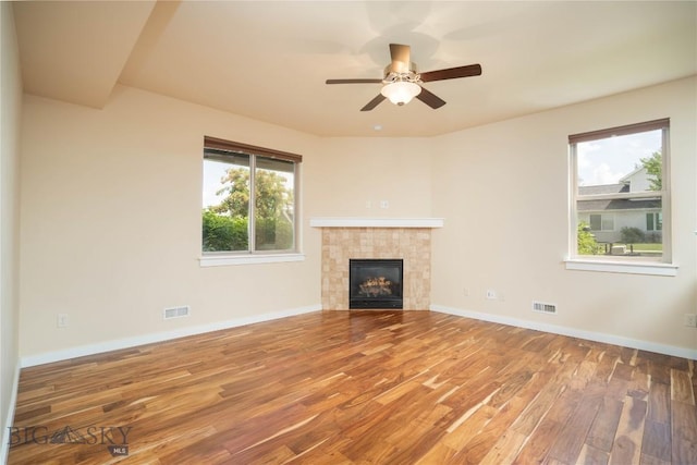 56 Koch Peak Ct, Bozeman, MT 59718 - unfurnished living room with wood finished floors, a fireplace, and ceiling fan
